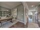 Hallway featuring hardwood floors that lead to a living room and a home office space at 247 Tackle Box Dr, Troutman, NC 28166