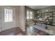 Bright home office featuring a large window, hardwood flooring, and a white front door at 247 Tackle Box Dr, Troutman, NC 28166