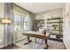Bright office space with large window, stylish shelving, and a wooden desk on a patterned rug at 247 Tackle Box Dr, Troutman, NC 28166