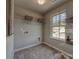 Well-lit laundry room features tile flooring, shelving, washer and dryer hookups at 247 Tackle Box Dr, Troutman, NC 28166