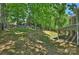 Expansive backyard, enhanced with mature trees and wooden fence, adjacent to a charming screened-in porch at 2544 Barrington Ct, Rock Hill, SC 29732