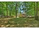 Lush backyard featuring a screened-in porch and mature trees offering privacy and shade at 2544 Barrington Ct, Rock Hill, SC 29732