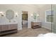Bright bathroom featuring double vanities, a soaking tub, and a glass shower and view to the main bedroom at 2544 Barrington Ct, Rock Hill, SC 29732