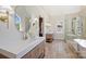 Bright and airy bathroom with double vanities, a soaking tub, and a glass shower, all with modern finishes at 2544 Barrington Ct, Rock Hill, SC 29732