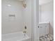 Inviting bathroom showcasing sleek, modern shower and tub featuring new white tile and attractive gold colored fixtures at 2544 Barrington Ct, Rock Hill, SC 29732
