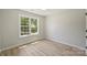 Small bedroom featuring a large window with a treed backyard view at 2544 Barrington Ct, Rock Hill, SC 29732
