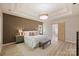This is a bedroom with a wood accent wall, a king bed, and a view into the Primary bath with a sliding barn door at 2544 Barrington Ct, Rock Hill, SC 29732