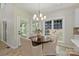 Dining room features a modern chandelier, neutral walls, and natural light from windows overlooking the backyard at 2544 Barrington Ct, Rock Hill, SC 29732