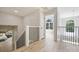 Bright hallway with modern railing and arched window nook, showcasing the home's architectural details and natural light at 2544 Barrington Ct, Rock Hill, SC 29732