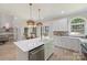 Bright kitchen features white cabinets, stainless appliances, island with sink, and an adjacent dining area at 2544 Barrington Ct, Rock Hill, SC 29732