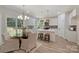 Bright kitchen features white cabinets, stainless appliances, island with breakfast bar, and an adjacent dining area at 2544 Barrington Ct, Rock Hill, SC 29732