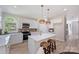 Bright kitchen features white cabinets, stainless appliances, island with breakfast bar, and natural light at 2544 Barrington Ct, Rock Hill, SC 29732