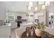 Bright kitchen features white cabinets, stainless appliances, island with breakfast bar, and an adjacent dining area at 2544 Barrington Ct, Rock Hill, SC 29732