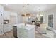 Bright kitchen features white cabinets, stainless appliances, island with sink, and an adjacent dining and living area at 2544 Barrington Ct, Rock Hill, SC 29732