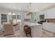 Bright kitchen features white cabinets, stainless appliances, island with breakfast bar, and an adjacent dining area at 2544 Barrington Ct, Rock Hill, SC 29732