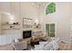 Bright living room with a fireplace, built-in shelves, large windows, comfortable seating, and a modern chandelier at 2544 Barrington Ct, Rock Hill, SC 29732