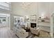 Open-concept living room featuring a fireplace, modern decor, and views into the dining and kitchen areas at 2544 Barrington Ct, Rock Hill, SC 29732