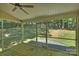 Relaxing screened-in porch with wooden floors offers a seamless transition to the backyard and its landscaped elements at 2544 Barrington Ct, Rock Hill, SC 29732