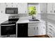 Modern kitchen features white cabinets and black appliances at 269 Bud Black Rd, Crouse, NC 28033