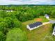 Aerial view of home surrounded by lush trees and large grassy yard on an overcast day at 301 Walkers Ridge Dr, Shelby, NC 28152