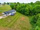 Aerial view of a home with a large, lush backyard surrounded by mature trees at 301 Walkers Ridge Dr, Shelby, NC 28152