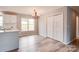 Dining room with hardwood floors, modern chandelier, large window, and closet space at 301 Walkers Ridge Dr, Shelby, NC 28152