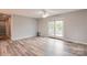 Spacious living room with light wood floors, ceiling fan, and a sliding door leading to the outside at 301 Walkers Ridge Dr, Shelby, NC 28152