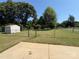 Backyard bordered by a chain link fence, with a storage shed and large trees at 318 Huffman Rd, Gastonia, NC 28056