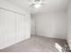 Bright bedroom with ceiling fan, light carpet, and closet at 318 Huffman Rd, Gastonia, NC 28056