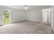 Bright, neutral bedroom with large window and ceiling fan at 318 Huffman Rd, Gastonia, NC 28056
