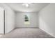 Spacious bedroom with neutral carpet, ceiling fan, and window view to the backyard at 318 Huffman Rd, Gastonia, NC 28056