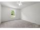 Bedroom with neutral carpet and a window overlooking the front yard at 318 Huffman Rd, Gastonia, NC 28056