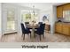 Bright dining area features bay window, chandelier, seating for four, and access to kitchen and outdoor areas at 318 Huffman Rd, Gastonia, NC 28056