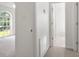 Bright hallway leads to the bedroom, featuring carpeted flooring and white walls at 318 Huffman Rd, Gastonia, NC 28056