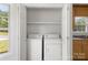 A convenient laundry closet with a washer and dryer is located near a window and utility sink at 318 Huffman Rd, Gastonia, NC 28056