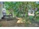 The home includes a spacious yard with mature trees and landscaping at 3226 Chatfield Sw Ln, Concord, NC 28027