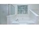 A soaking tub sits beneath a window inside this relaxing bathroom, perfect for unwinding after a long day at 3226 Chatfield Sw Ln, Concord, NC 28027