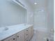 Bright bathroom featuring a dual sink vanity, framed mirror, and a tile floor at 3226 Chatfield Sw Ln, Concord, NC 28027