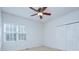 This cozy bedroom features carpeted floors, a ceiling fan, a closet and a window that lets in natural light at 3226 Chatfield Sw Ln, Concord, NC 28027