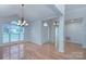 Light-filled dining area with hardwood floors, chandelier, and open entryway at 3226 Chatfield Sw Ln, Concord, NC 28027