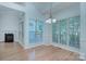 Bright dining area with hardwood floors, fireplace, lots of windows, and chandelier lighting at 3226 Chatfield Sw Ln, Concord, NC 28027