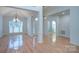 Bright dining room with hardwood floors, elegant chandelier, and natural light at 3226 Chatfield Sw Ln, Concord, NC 28027