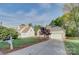 Well-maintained home with an attached garage, manicured lawn, and mature trees at 3226 Chatfield Sw Ln, Concord, NC 28027