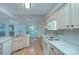 Bright kitchen features neutral cabinets, a center island and an open-concept layout to dining room at 3226 Chatfield Sw Ln, Concord, NC 28027