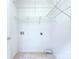 Functional laundry room with white walls, tile flooring, and efficient wire shelving at 3226 Chatfield Sw Ln, Concord, NC 28027