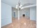 Open-concept living room with hardwood floors, fireplace, and modern lighting at 3226 Chatfield Sw Ln, Concord, NC 28027