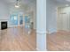 Open concept living room with hardwood floors, fireplace, lots of natural light, and neutral color palette at 3226 Chatfield Sw Ln, Concord, NC 28027