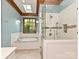 Bright bathroom with soaking tub, glass shower, and charming window view at 3231 Karen Ln, Monroe, NC 28110