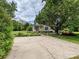 Home with a driveway, basketball hoop, and landscaped garden at 3231 Karen Ln, Monroe, NC 28110