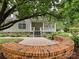 Charming home featuring a circular brick patio and lush landscaping at 3231 Karen Ln, Monroe, NC 28110